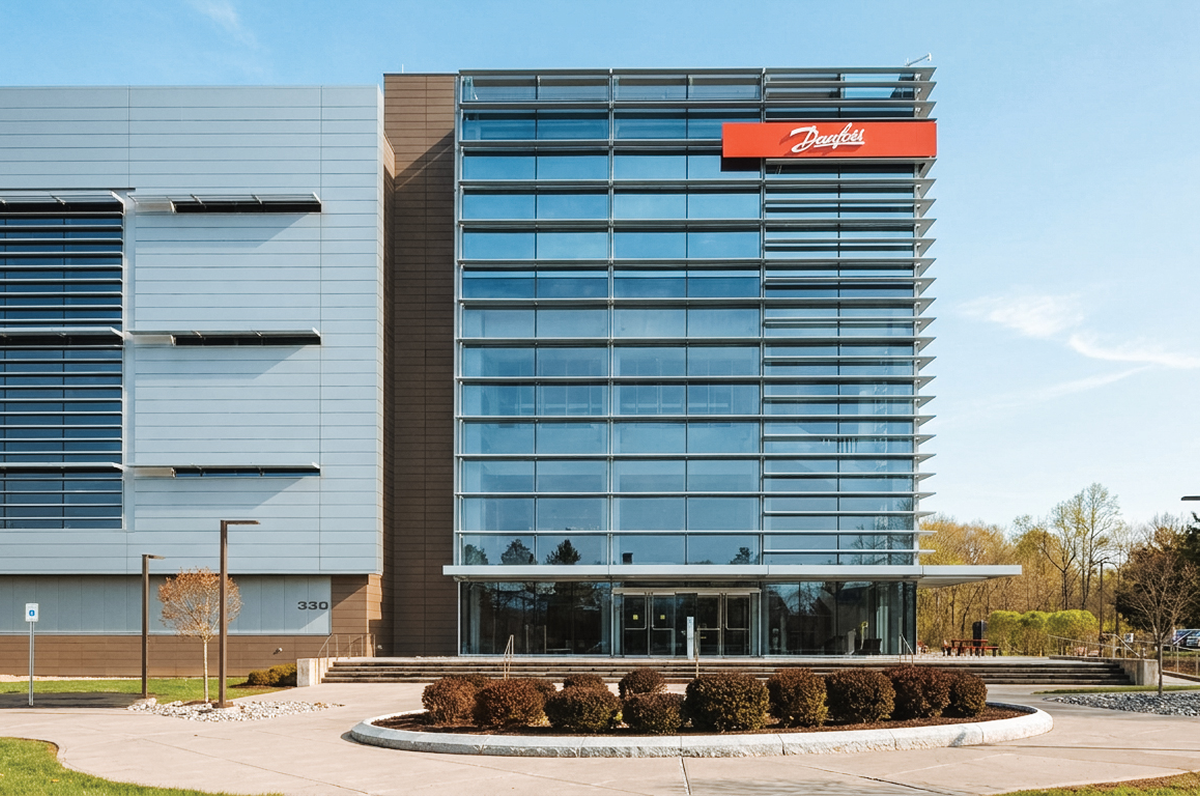 Glass-and-metal office building with a red Danfoss sign above the entrance.
